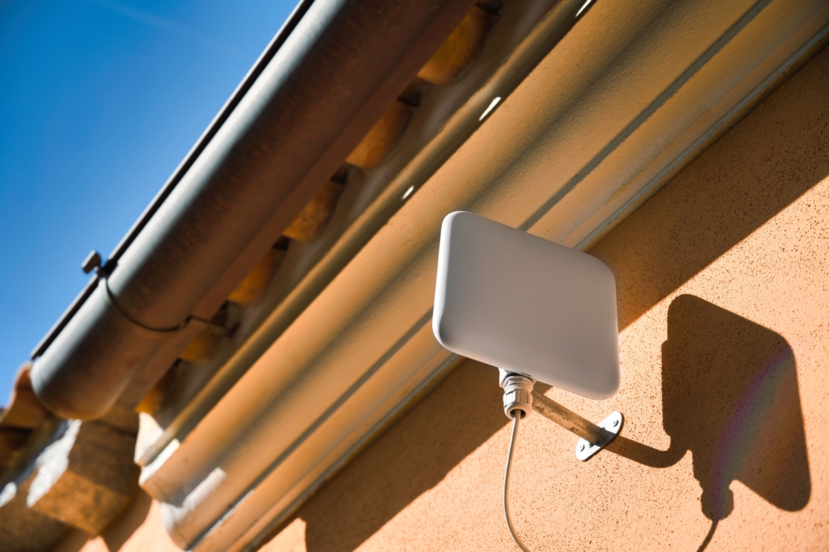 A CPE device for fixed wireless attached to the side of a building.